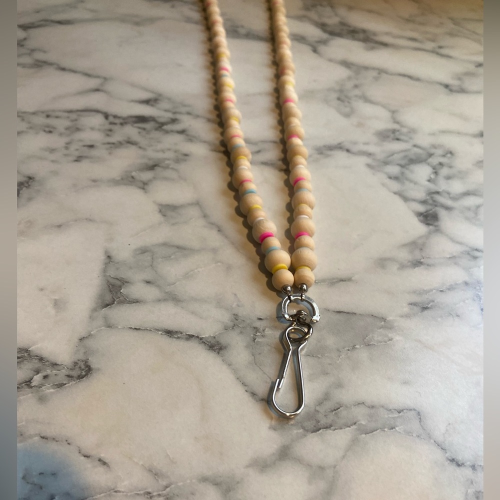 All natural wooden beads and clay. Badge holder.